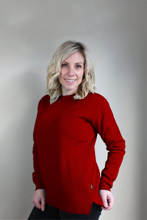 A lady wearing an Australian Made, Ballarat Gold merino wool moss crew jumper in Sangria Red