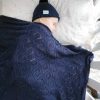 Branberry Heirloom Blanket in Princeton, a baby serenely sleeping in a cot with the matching Pure Wool Frankie Beanie