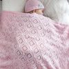 Branberry Heirloom Blanket in Pink Silk, a second adorable image of a baby sleeping peacefully in a cot with the matching Pure Wool Frankie Beanie.