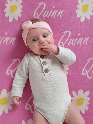 Taffy Pink Personalised Wool Name Blanket - Adorable baby laid on the softness. Crafted from Pure Australian Merino Wool, proudly Made in Australia.