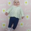 A baby laying on a Personalised Name Blanket with Daisy flowers in a Pastel Pink colour. Made from Pure Australian Merino Wool and Made in Australia.