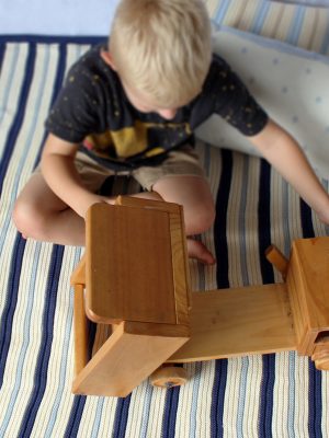 Boy playing with dump truck on Navy, Blue & White Striped Garter Stitch Blanket