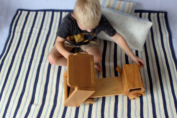Boy playing with dump truck on Navy, Blue & White Striped Garter Stitch Blanket