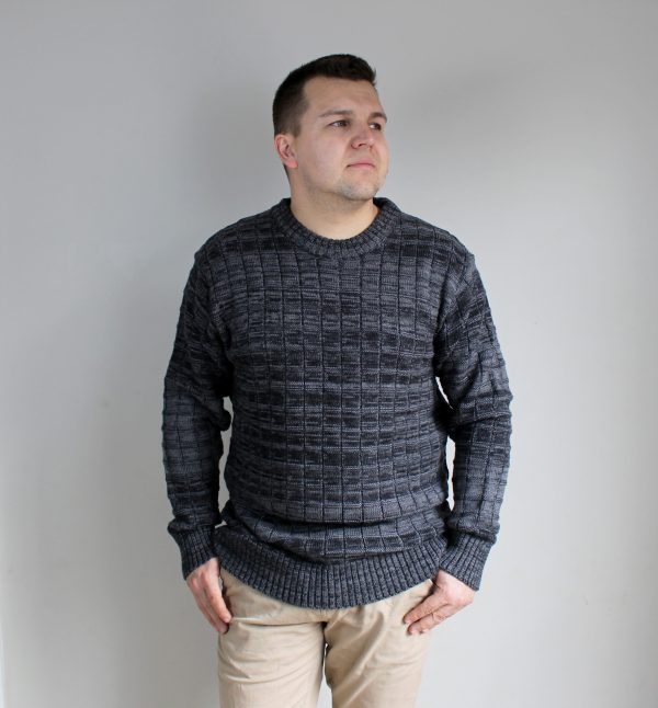 A man wearing Stormy Grey, Michael Bricks designed jumper, showcasing the intricate knit detail and grey marl colours.